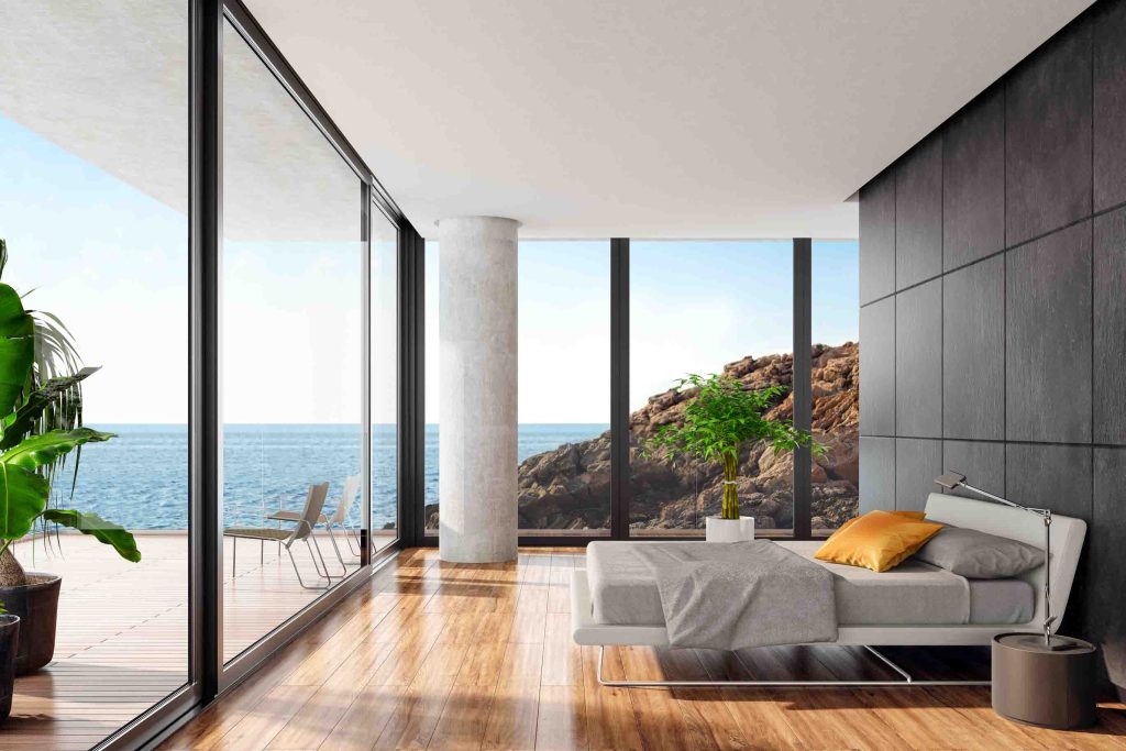 Modern luxurious bedroom in a seaside villa with black stone wall ...